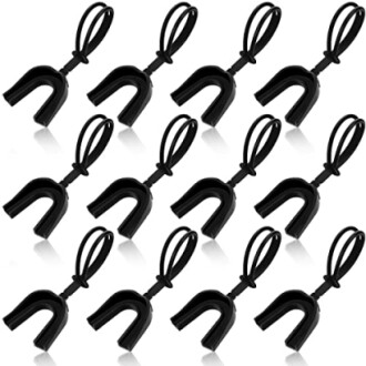 Multiple black mouthguards with straps arranged in a pattern.