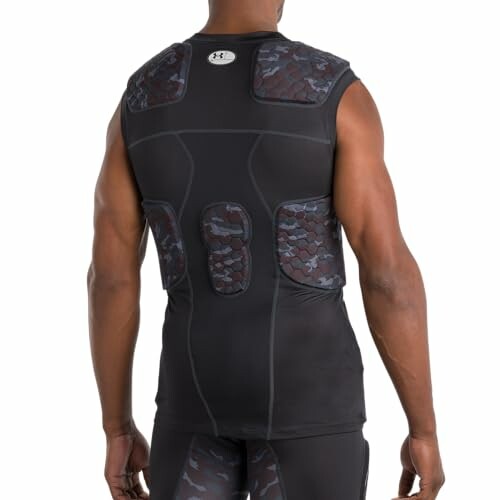 Man wearing a black compression shirt with padded areas.