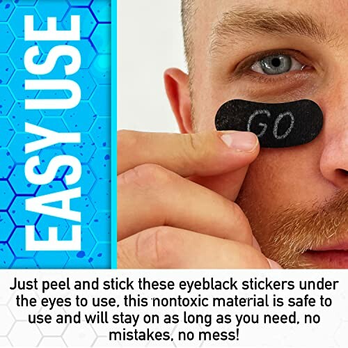 Man applying easy use eyeblack sticker under eye.