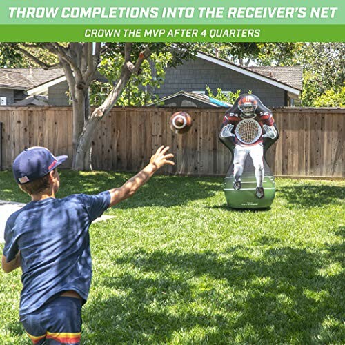 Child throwing football into receiver's net in backyard.