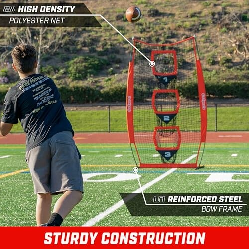 Person practicing football throw using a target net on a field.