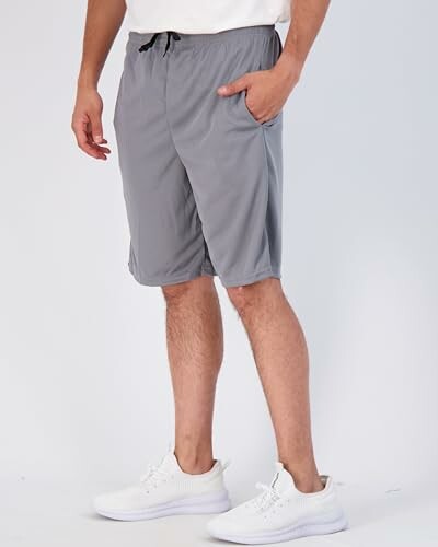 Person wearing gray athletic shorts and white sneakers.