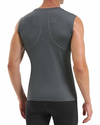 Back view of a man wearing a grey sleeveless compression shirt.