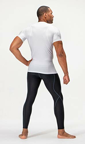 Man in athletic wear with white shirt and black leggings.