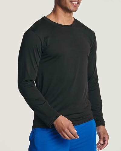 Man in black long-sleeve shirt and blue pants.