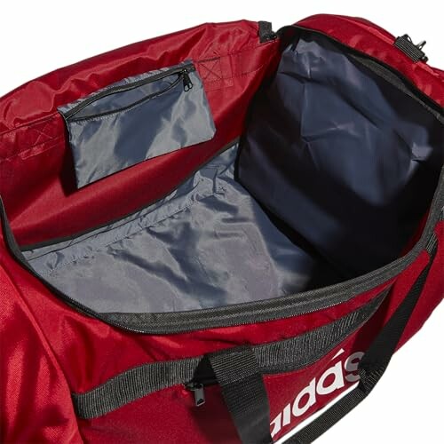 Open red duffel bag showing interior compartments.