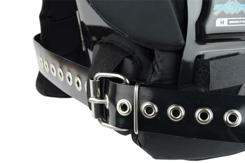 Close-up of a weightlifting belt with metal buckles and grommets.