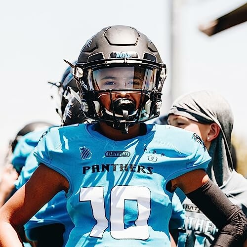 Youth football player in blue jersey and helmet